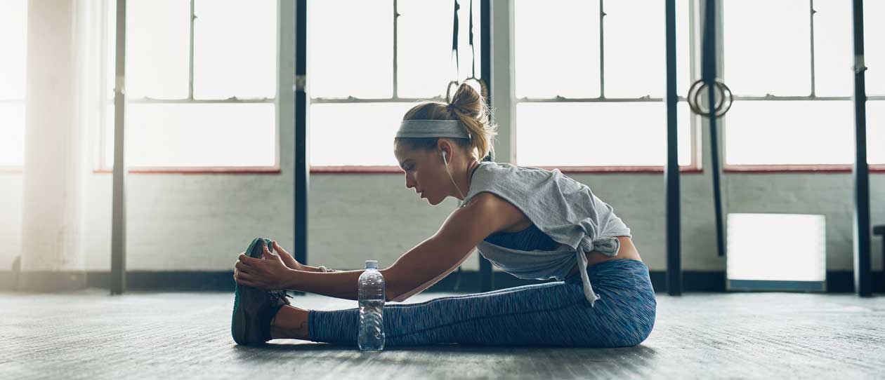 Woman stretching in the gym after a workout