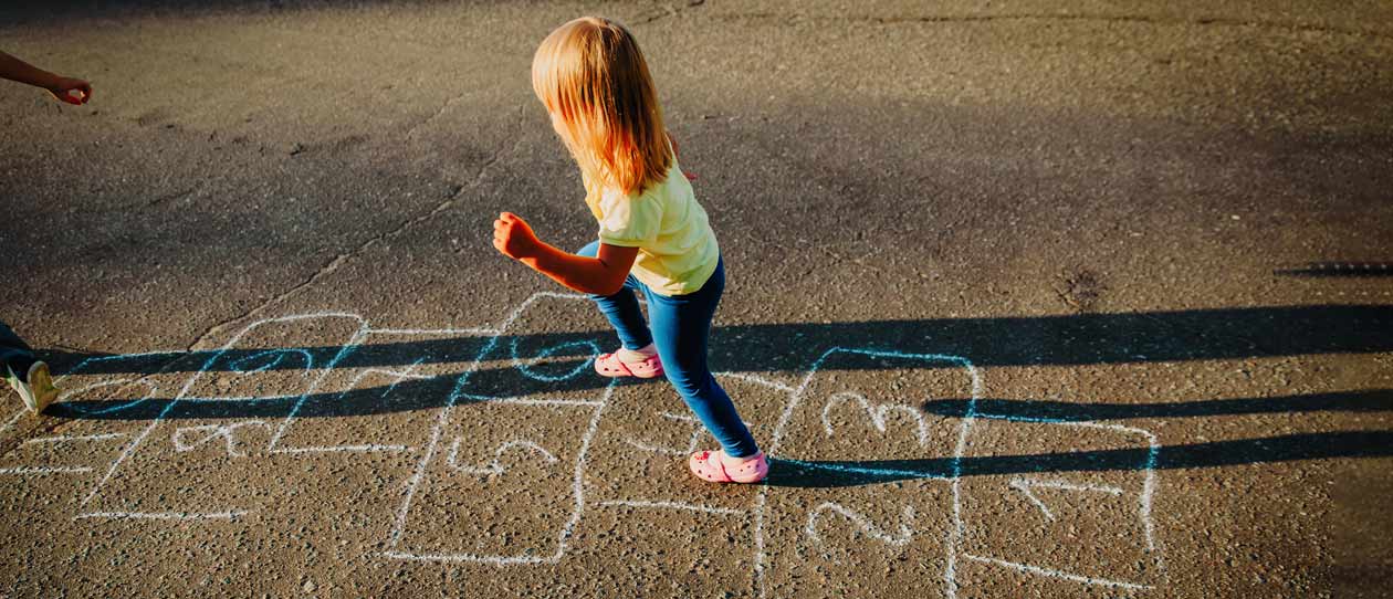 Sister and brother playing hopscotch