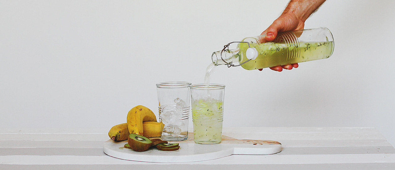 Someone pouring fruit juice into cups